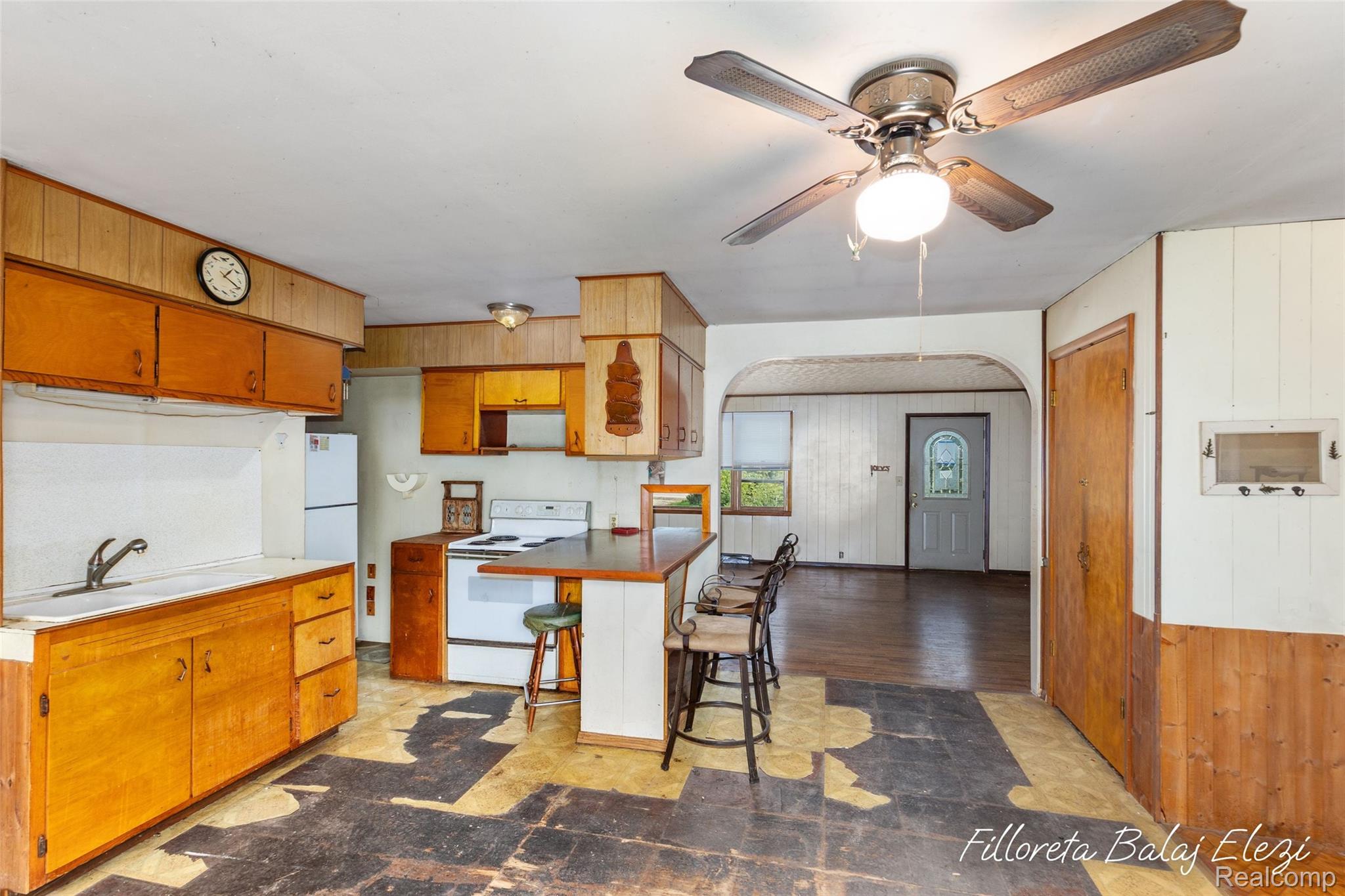 1624 5th Street Martin, MI 49070 - Photo 4 of 20 Kitchen area featuring wood-finish cabinetry, a built-in sink, and white appliances