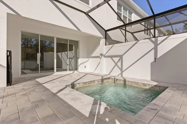 a view of a kitchen with kitchen island a sink wooden floor and a large window