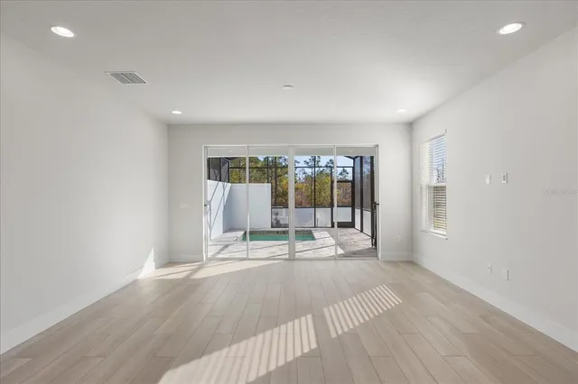 a kitchen with granite countertop a sink and a wooden floor