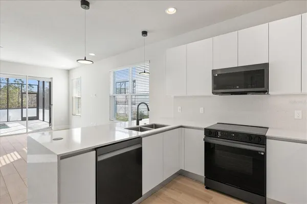 a view of a room with wooden floor and windows