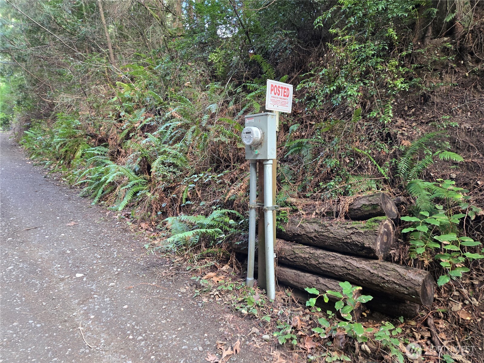 216-xx Bond Road Northeast Poulsbo, WA 98370 - Photo 6 of 26 a street sign on a sidewalk next to a road