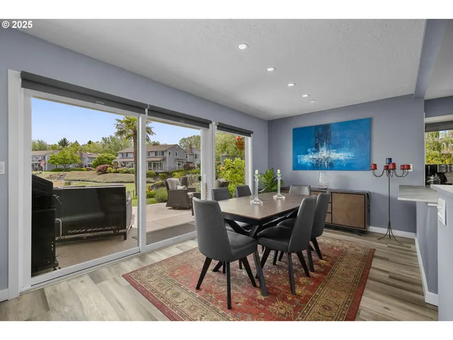 a dining room with furniture a fireplace and wooden floor