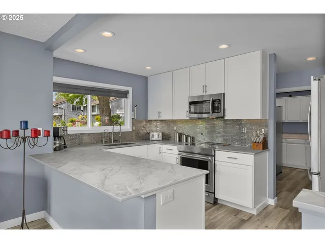 a kitchen that has a sink and a stove in it