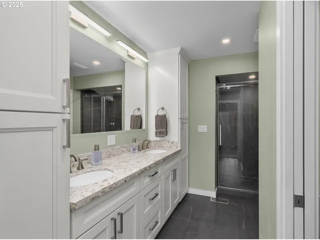 a bathroom with a granite countertop sink and a mirror
