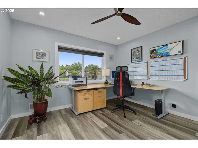 a living room with furniture and potted plants