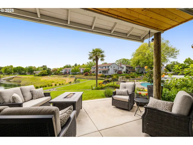 a view of swimming pool with couches and city view