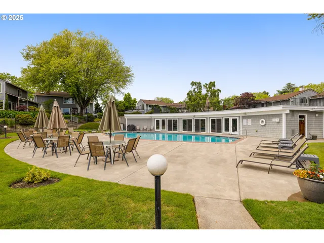a front view of a house with garden and sitting area