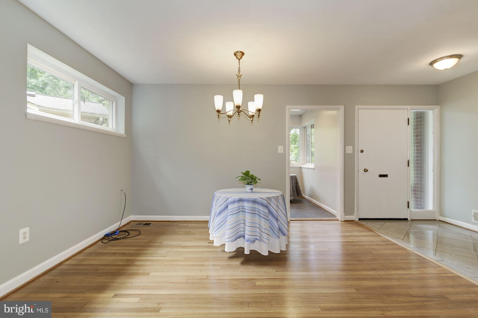10709 Glenwild Road Silver Spring, MD 20901 - Photo 4 of 30 a room with wooden floor chandelier and windows