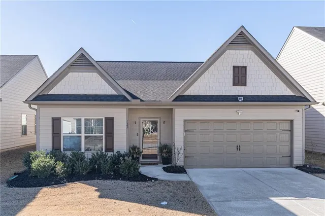 a front view of a house with garden