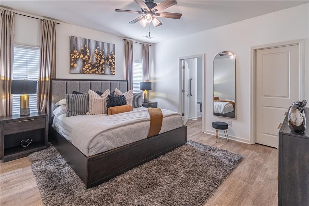 723 Independence Avenue Pendergrass, GA 30567 - Photo 11 of 22 a bedroom with a bed a rug and wooden floor