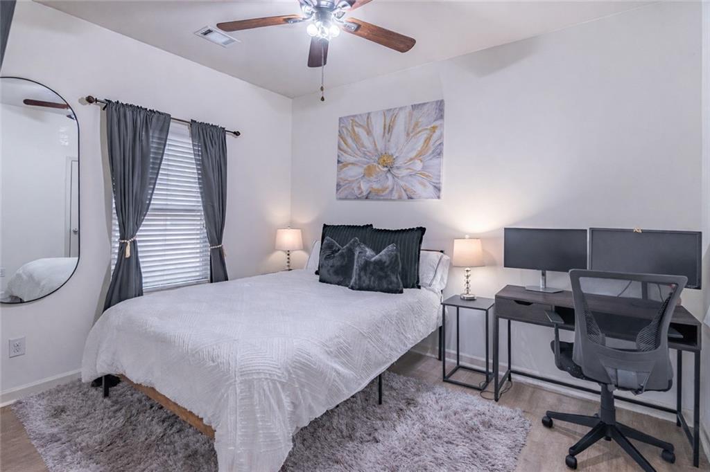 723 Independence Avenue Pendergrass, GA 30567 - Photo 14 of 22 a bedroom with a bed and a chandelier