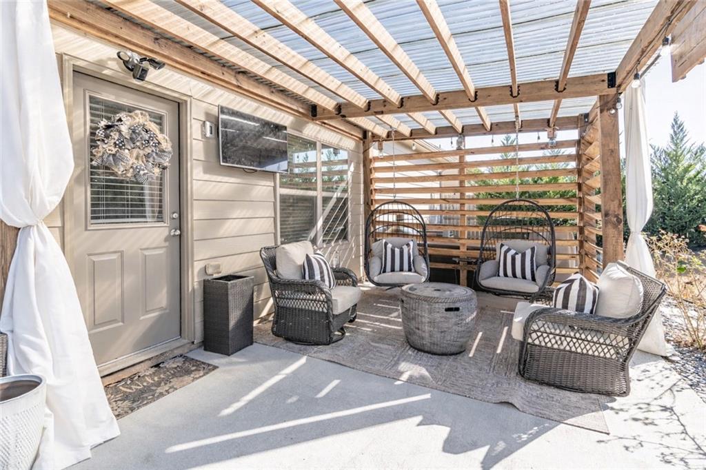 723 Independence Avenue Pendergrass, GA 30567 - Photo 17 of 22 a living room with furniture and a floor to ceiling window
