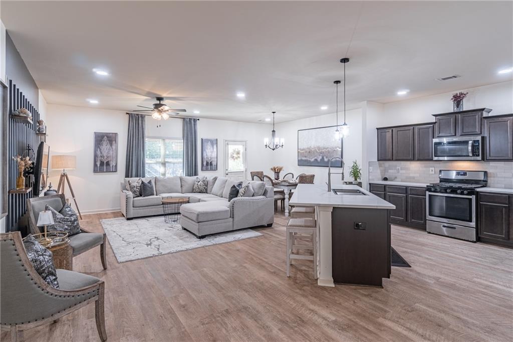 723 Independence Avenue Pendergrass, GA 30567 - Photo 4 of 22 a living room filled with furniture and kitchen view