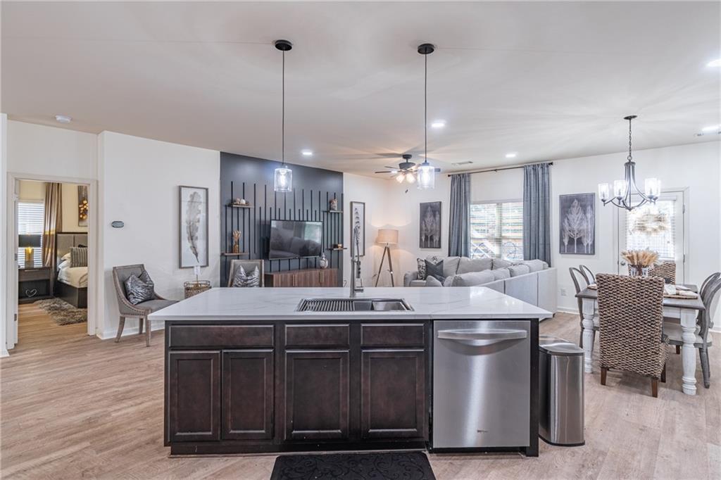 723 Independence Avenue Pendergrass, GA 30567 - Photo 9 of 22 a kitchen with kitchen island stainless steel appliances a dining table chairs and wooden floor