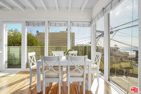 a view of a living room with a large window and front door