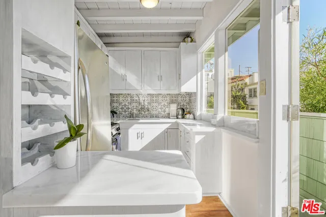 a building outdoor space with patio furniture and potted plants