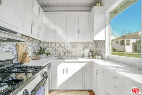 a room with lots of table and a large window