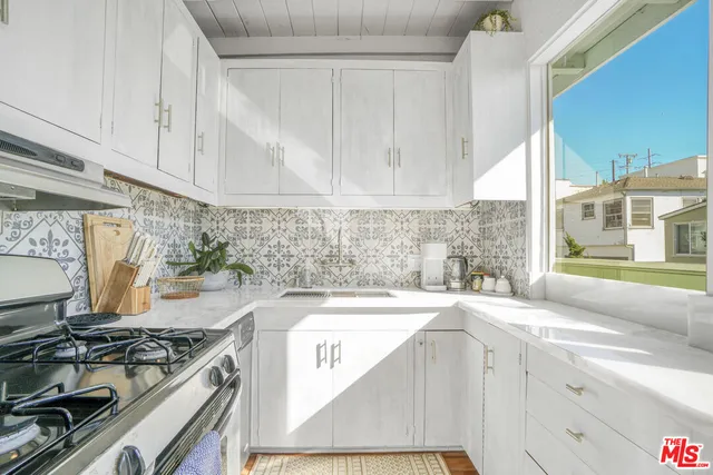 a room with lots of table and a large window