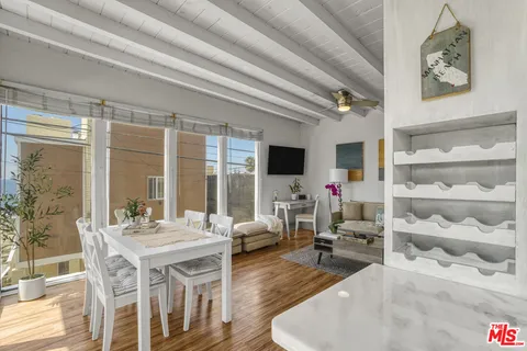 a living room with furniture wooden floor and a large window