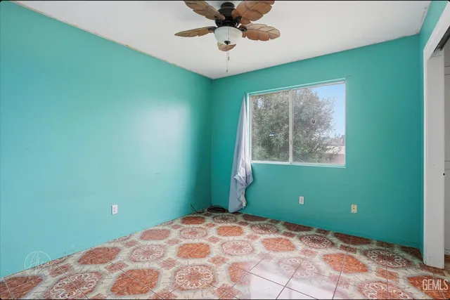 a view of a room with a window and ceiling fan