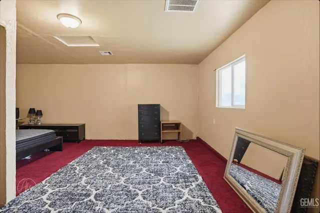 a bedroom with a bed and a rug