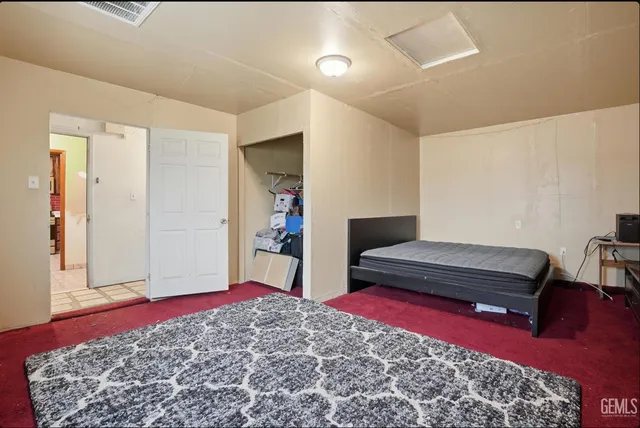 a bedroom with furniture and a rug