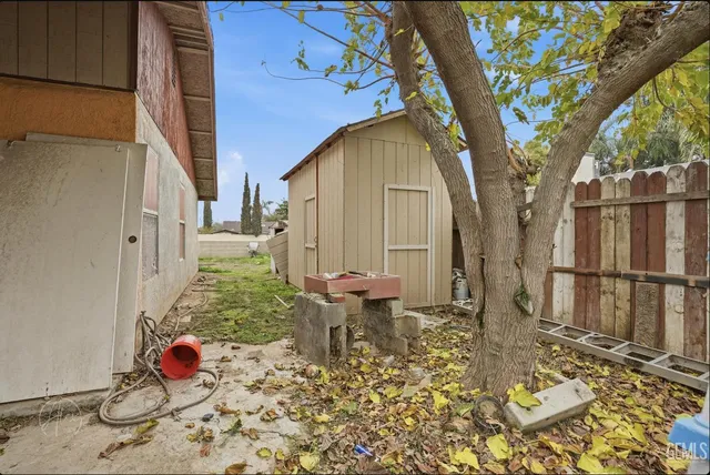 a backyard of a house with table and chairs