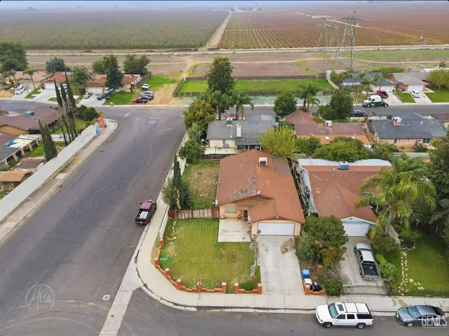 an aerial view of a house with a garden and lake view