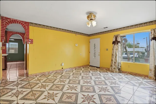 a view of a hallway with wooden floor and a table