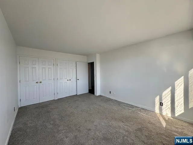a view of an empty room and a window