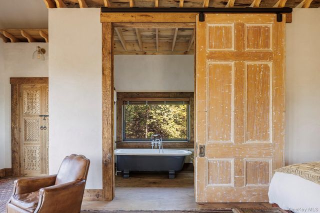 a living room with furniture a clock and a rug