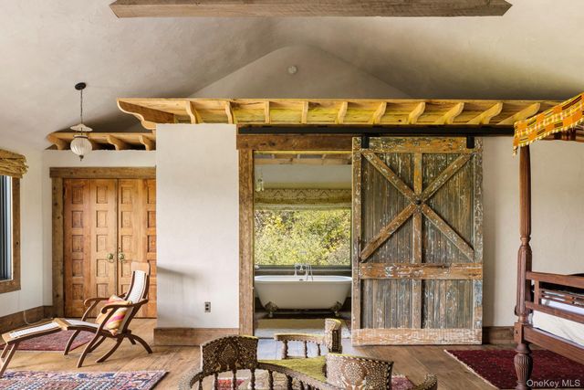 a bed sitting in a bedroom next to a window