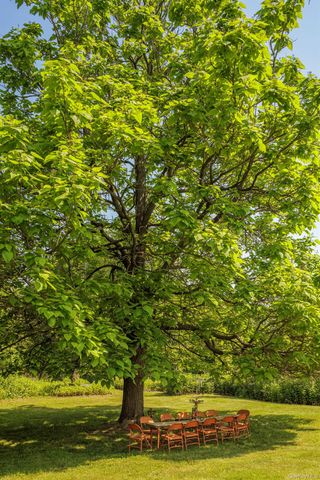 a outdoor space with patio the couches and a fireplace with potted plants