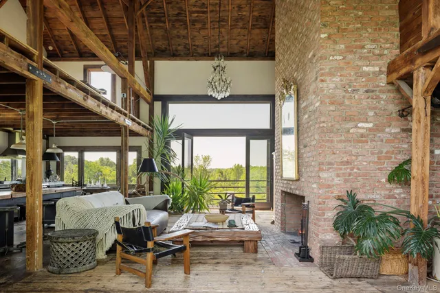 a outdoor living area with furniture and a fireplace