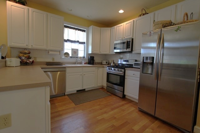 241 Starcrest Road Charlottesville, VA 22902 - Photo 8 of 29 a kitchen with stainless steel appliances granite countertop a refrigerator a sink a stove a microwave and island
