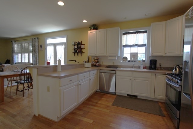 241 Starcrest Road Charlottesville, VA 22902 - Photo 9 of 29 a kitchen with a sink stove cabinets and wooden floor