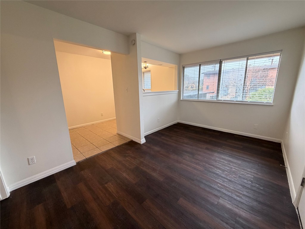 3304 Red River Street, Unit 206 Austin, TX 78705 - Photo 2 of 16 an empty room with wooden floor and windows