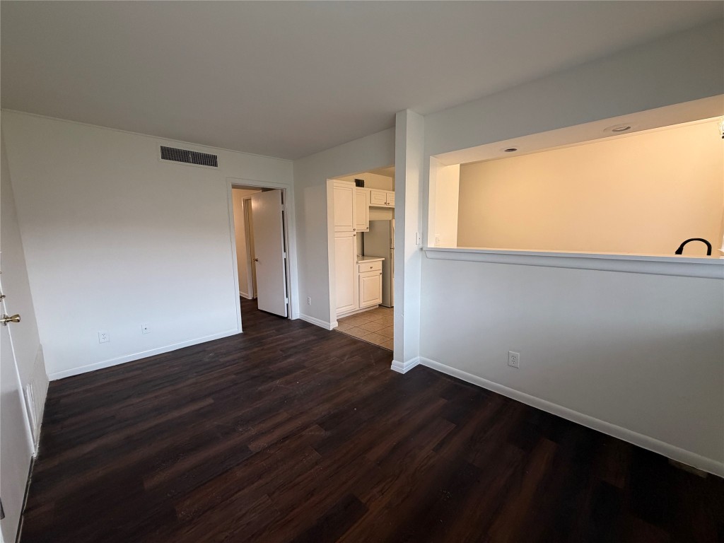 3304 Red River Street, Unit 206 Austin, TX 78705 - Photo 3 of 16 a view of an empty room with wooden floor and a window