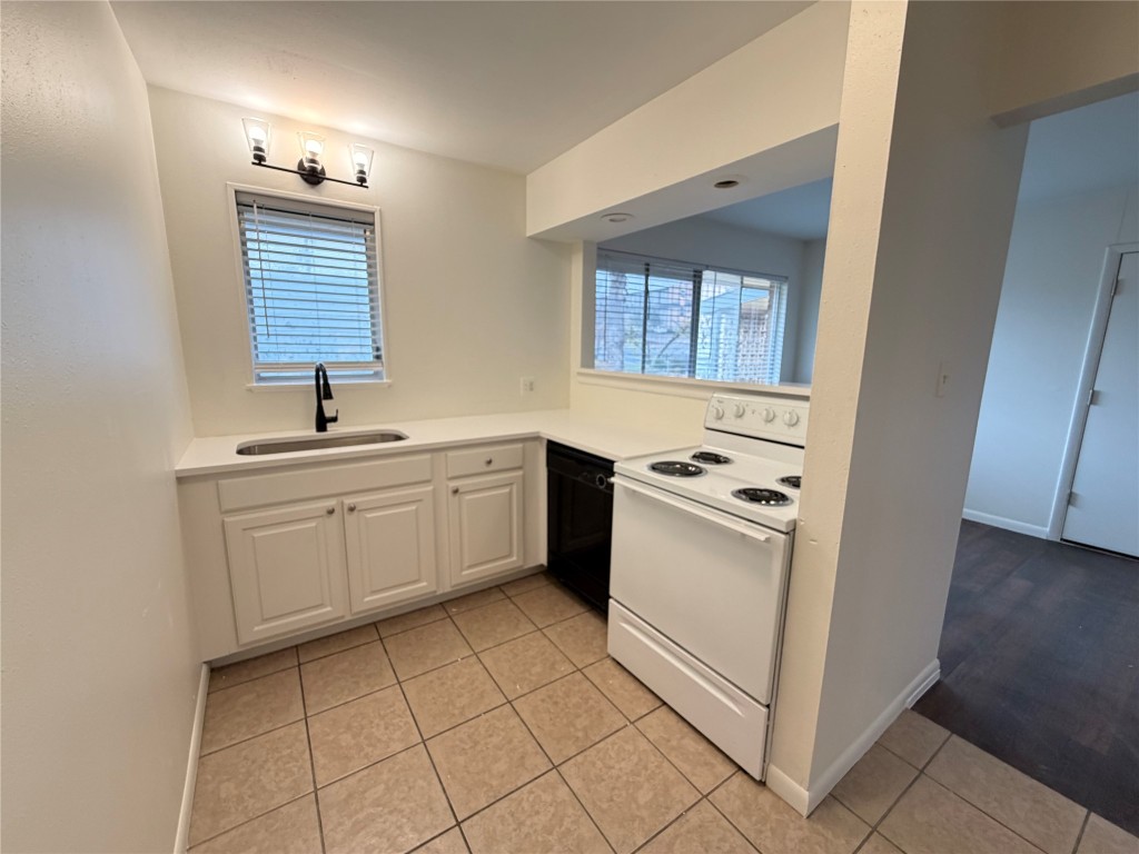 3304 Red River Street, Unit 206 Austin, TX 78705 - Photo 4 of 16 a kitchen with a white stove top oven and sink