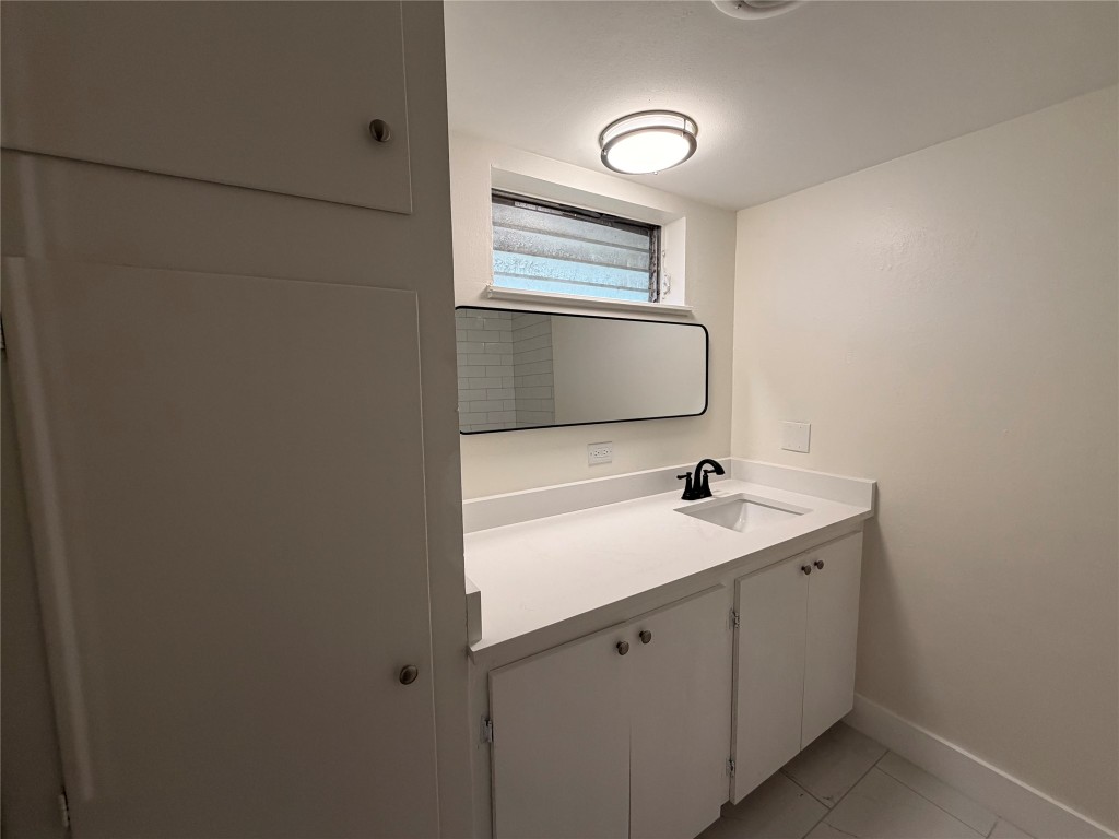 3304 Red River Street, Unit 206 Austin, TX 78705 - Photo 8 of 16 a bathroom with a sink and a mirror
