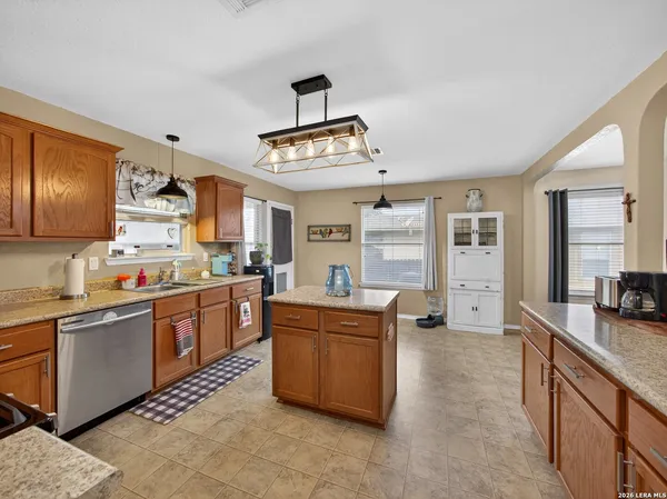 a kitchen with stainless steel appliances granite countertop a sink and cabinets