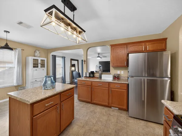 a kitchen with stainless steel appliances a sink and a refrigerator