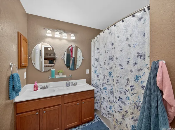 a bathroom with a sink vanity and mirror