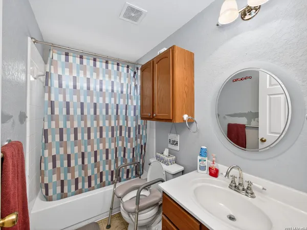 a bathroom with a sink vanity and a mirror