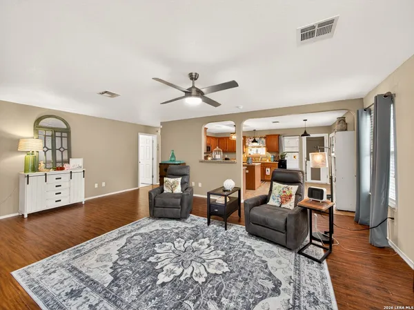 a living room with furniture and wooden floor