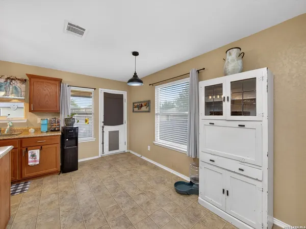 a large kitchen with stainless steel appliances kitchen island granite countertop a refrigerator and a stove top oven