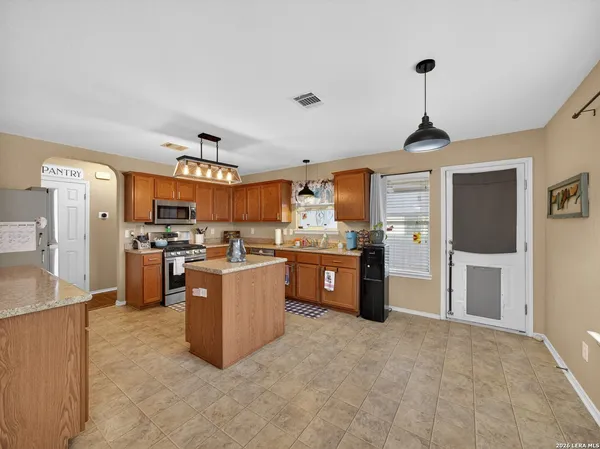a kitchen with stainless steel appliances granite countertop a refrigerator a sink dishwasher stove and oven