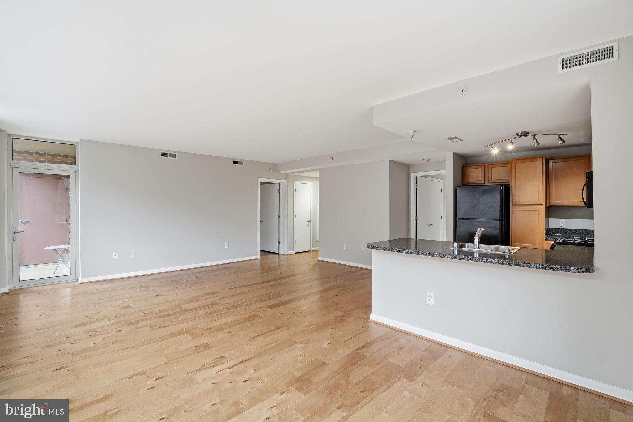 350 G Street Southwest, Unit N302 Washington, DC 20024 - Photo 31 of 32 a view of a kitchen with a sink and a large mirror