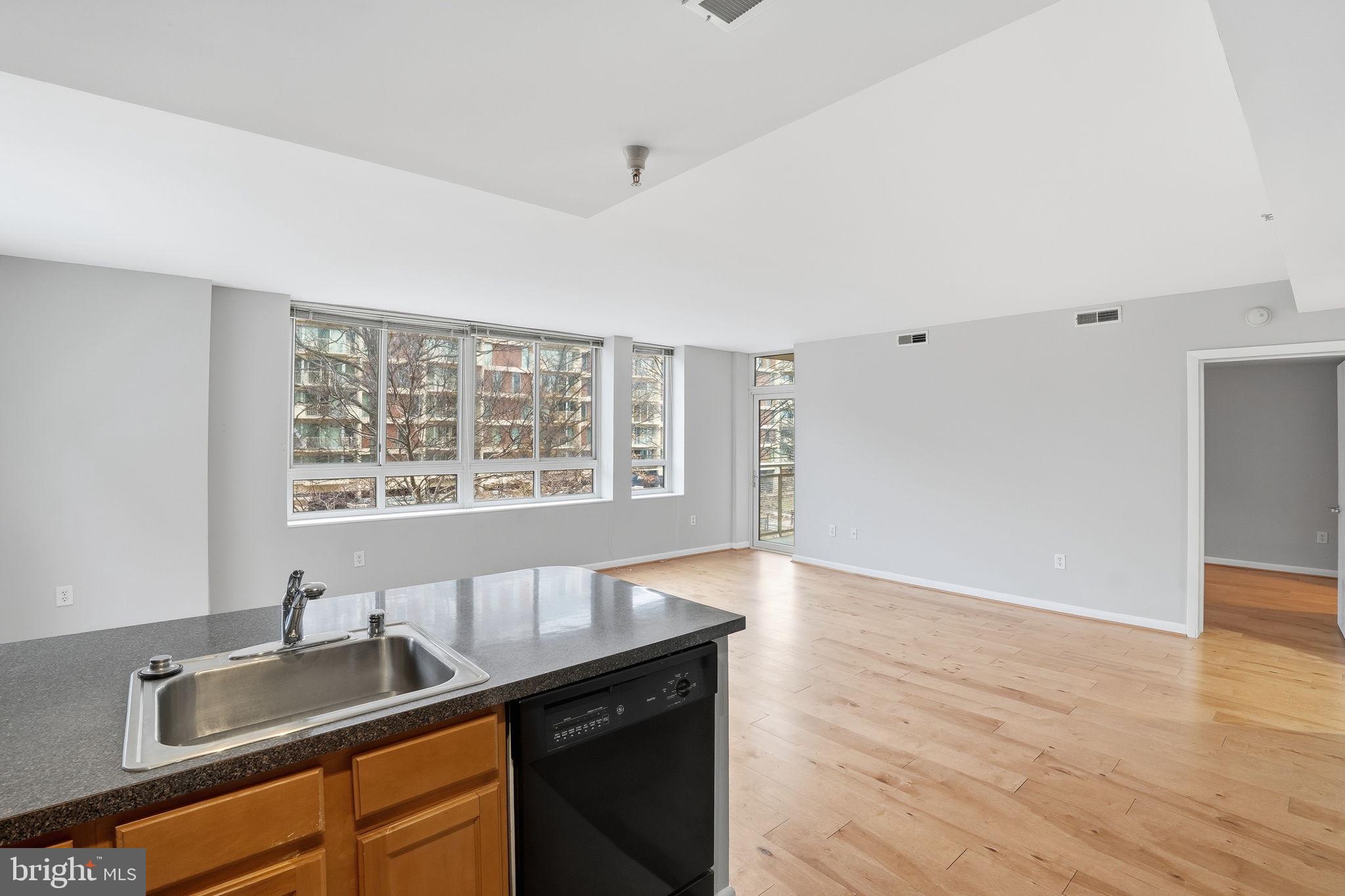 350 G Street Southwest, Unit N302 Washington, DC 20024 - Photo 32 of 32 a kitchen with granite countertop a sink wooden floor and a window