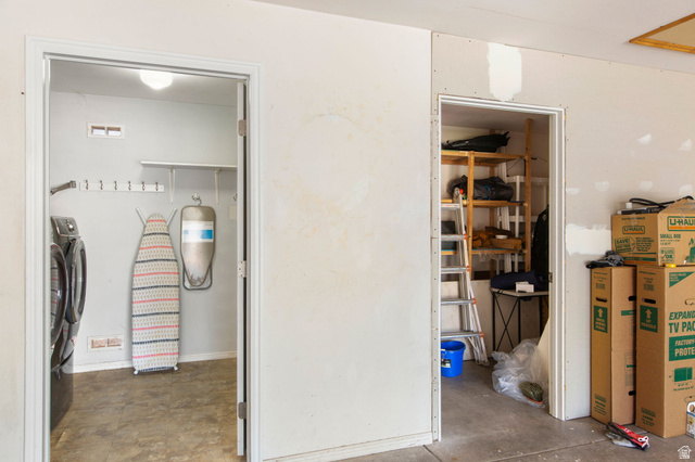 664 East Springhill Drive Washington, UT 84780 - Photo 17 of 21 Utility space featuring a washer and dryer hookup, built-in wall shelving, and a wall-mounted coat rack